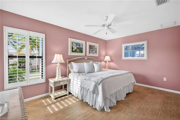 Room featuring wood-finish flooring and a ceiling fan