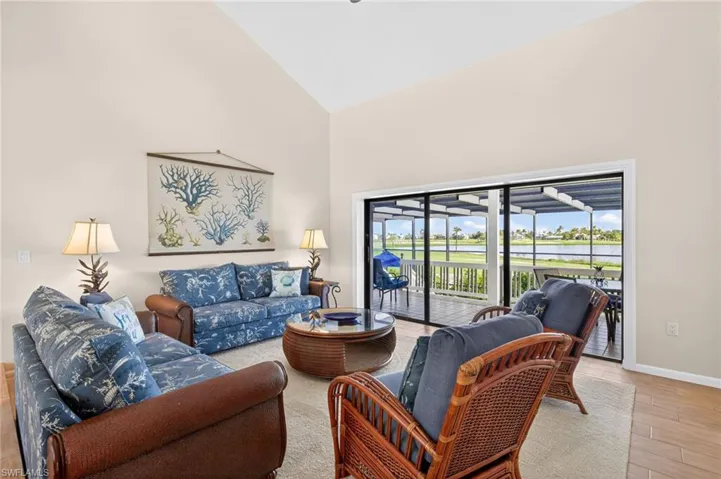 Bright interior featuring a vaulted ceiling and sliding glass doors
