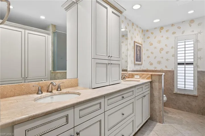 Dual vanity with light-toned countertops and undermount sinks