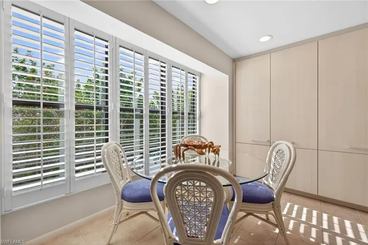 Wall of plantation shutters with exterior landscaping beyond