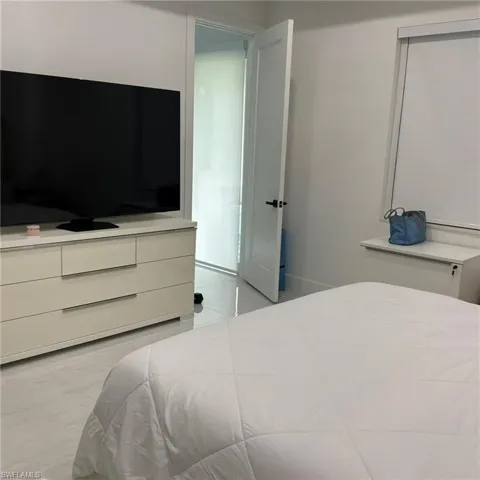 Spacious interior featuring pristine white walls and large format tile flooring