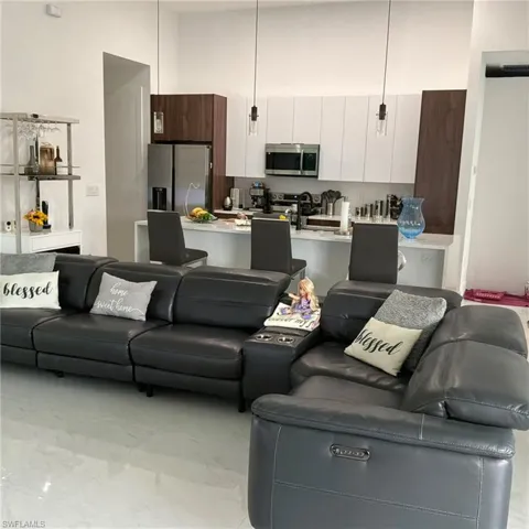 Open-concept living area featuring polished tile flooring