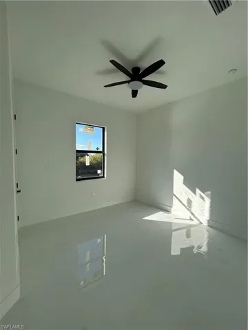 Unfurnished room featuring baseboards and a ceiling fan