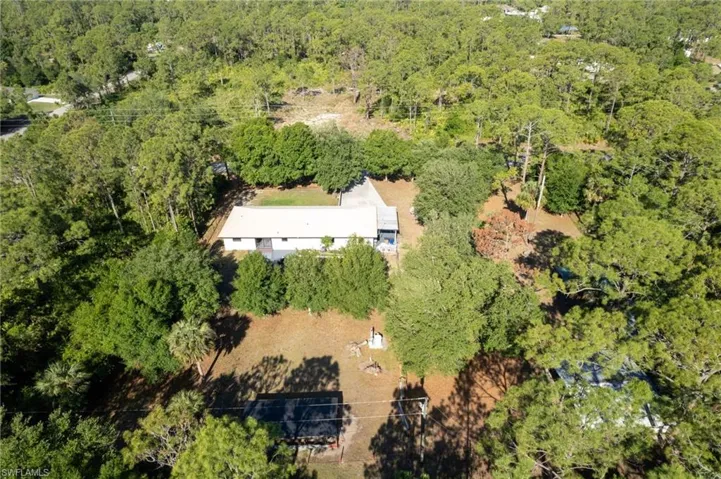 Birds eye view of property with a view of trees