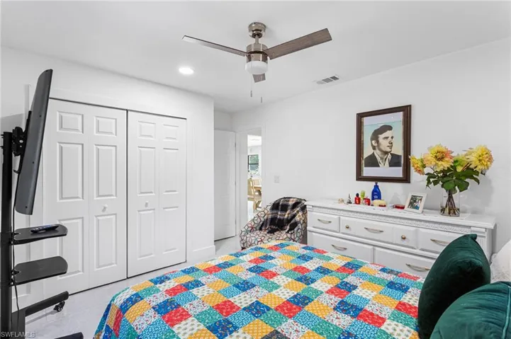 Bedroom with a ceiling fan, a closet, light tile patterned floors, visible vents, and recessed lighting