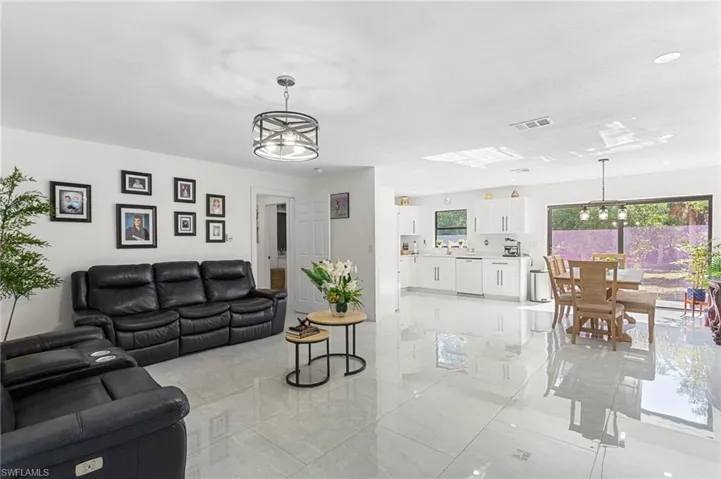 Living area with visible vents and a chandelier