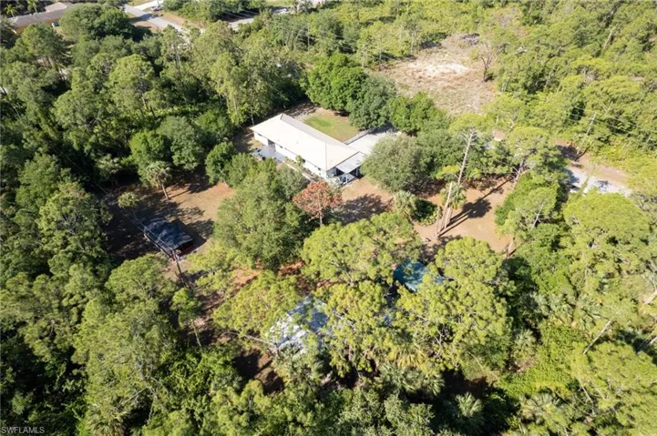Drone / aerial view featuring a wooded view