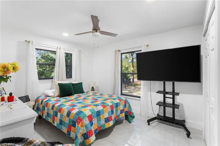Bedroom featuring baseboards, a ceiling fan, and recessed lighting
