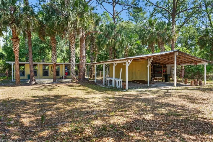 View of property's community featuring a carport and an outbuilding