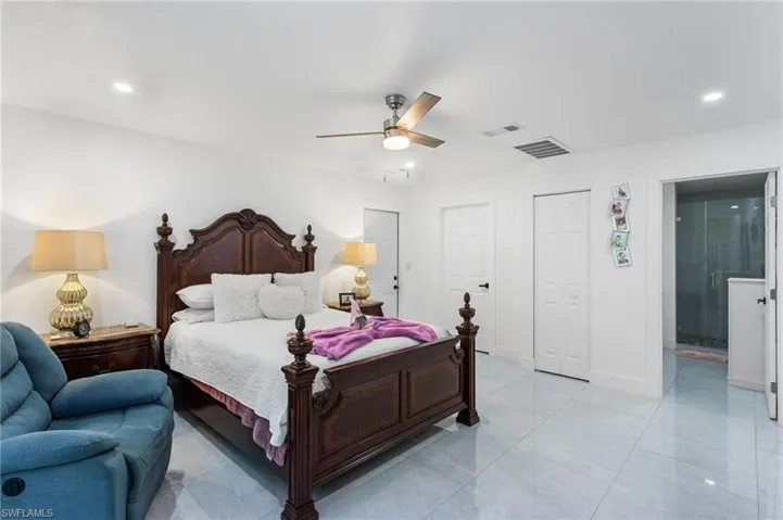Bedroom featuring visible vents, recessed lighting, and connected bathroom