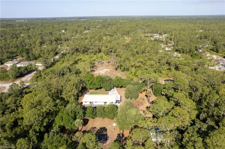 Aerial view featuring a forest view