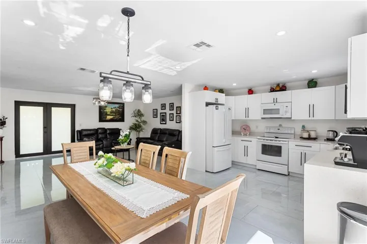 Dining area with recessed lighting, visible vents, and french doors
