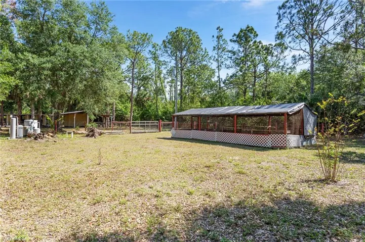 View of yard featuring fence and an outdoor structure