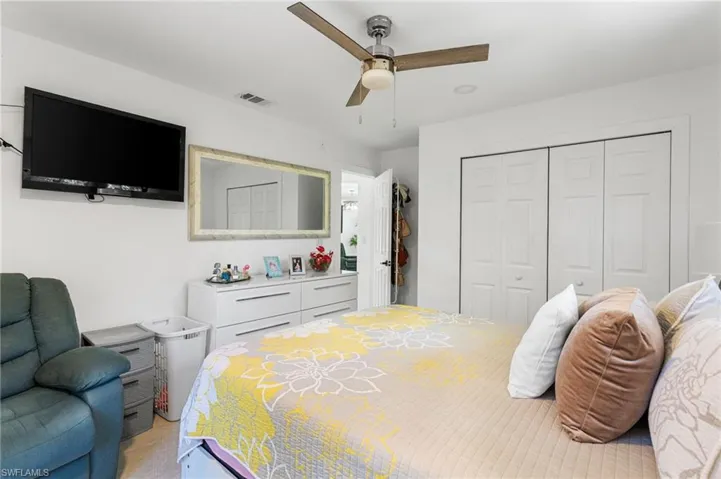 Bedroom featuring visible vents, a closet, and ceiling fan