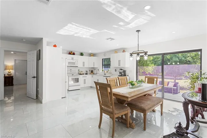 Dining space with baseboards, visible vents, recessed lighting, and marble finish floor
