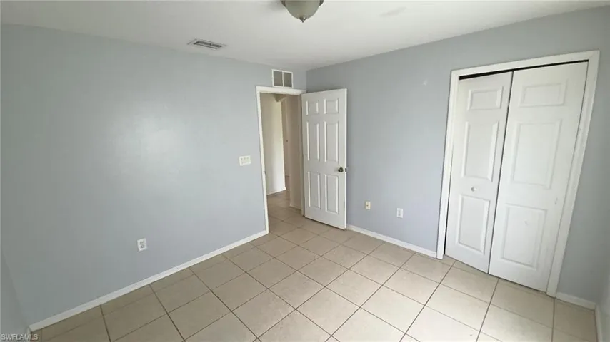 Neutral-toned ceramic tile flooring extending throughout the space