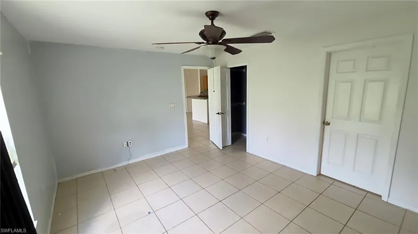 Interior space featuring neutral-toned square tile flooring throughout
