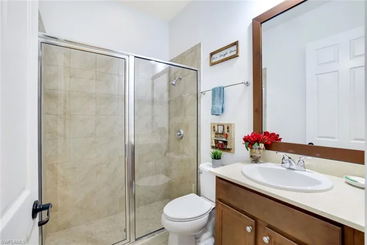 Bathroom featuring vanity and a stall shower
