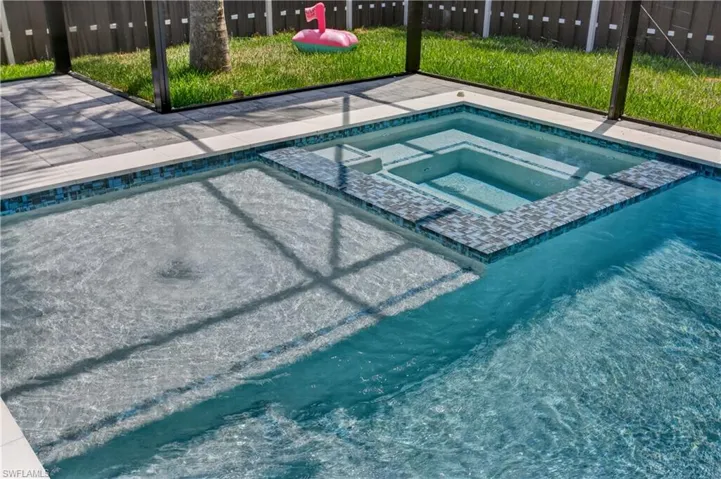 Relax in your private HEATED SPA, perfectly designed for YEAR-ROUND SWFL outdoor living and sunset evenings under the stars!