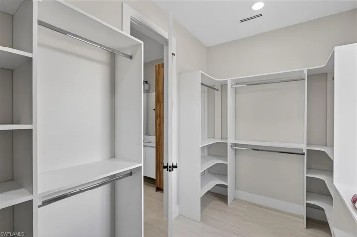 BUILT-IN CUSTOM CLOSET WHITE CABINETRY provides ADDED STORAGE & CLEAN, UPSCALE LOOK