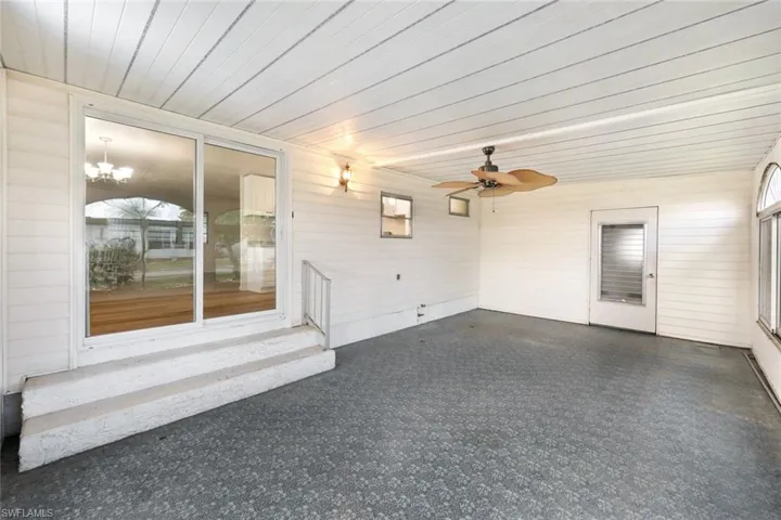 Unfurnished sunroom with a chandelier