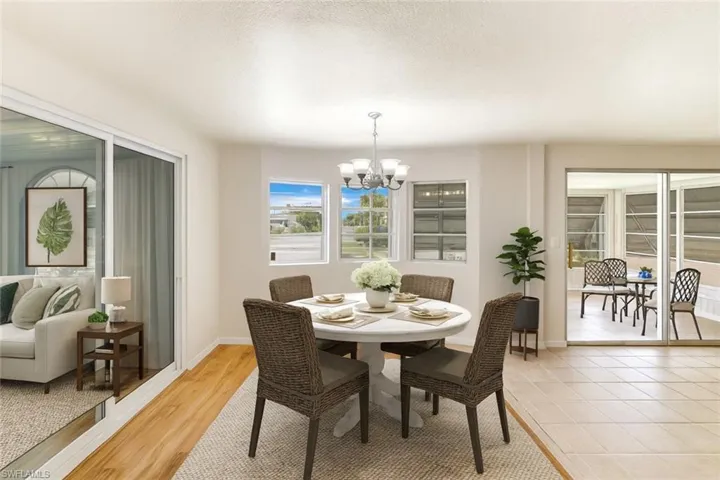 Dining room with a chandelier, a textured ceiling, and light wood-type flooring