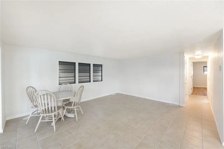Dining space with light tile patterned floors and a textured ceiling