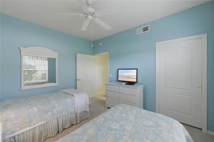 Bedroom with light carpet and ceiling fan