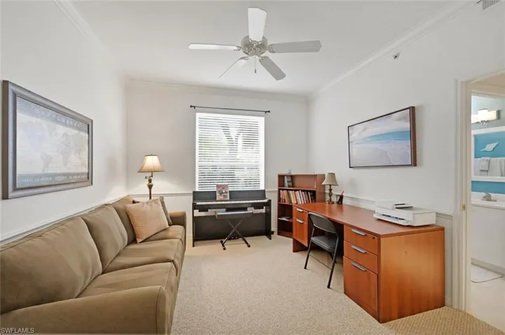 Office space featuring ornamental molding, light colored carpet, and ceiling fan