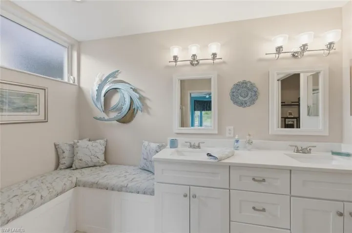 Bathroom featuring double vanity and plenty of natural light