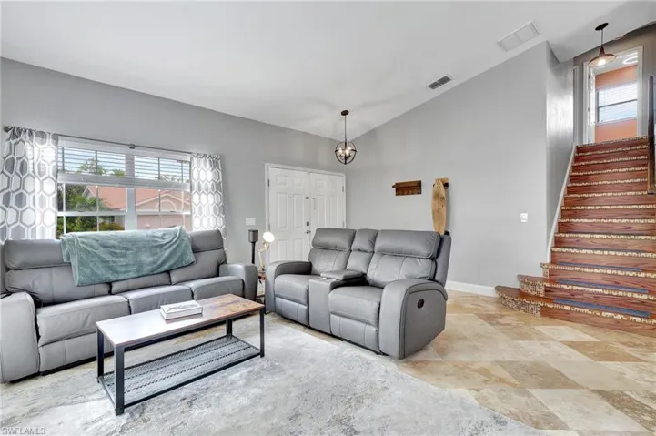 Tiled living room  showing the stairs to the 2nd floor