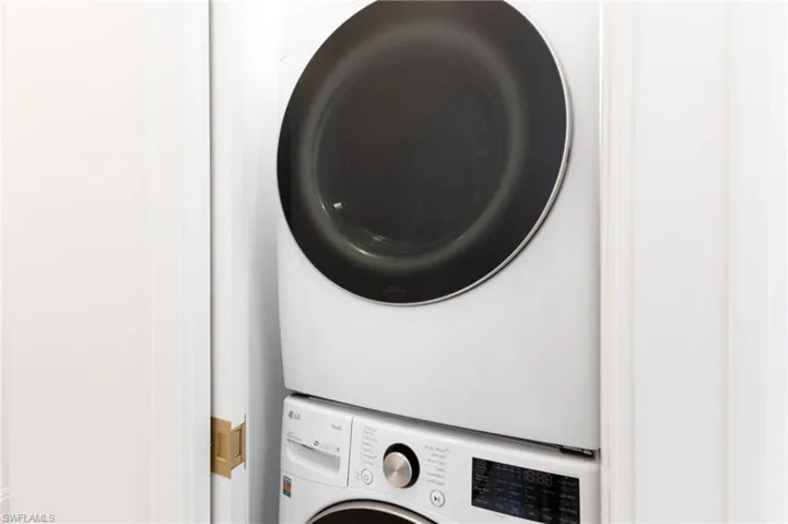 Upstairs Laundry area featuring stacked washer and dryer