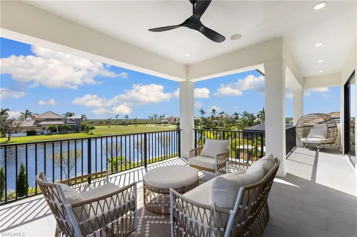 Balcony featuring a ceiling fan, a water view, and an outdoor hangout area