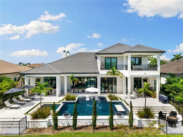 Rear view of property with a patio, outdoor dining space, stucco siding, a balcony, and a tile roof
