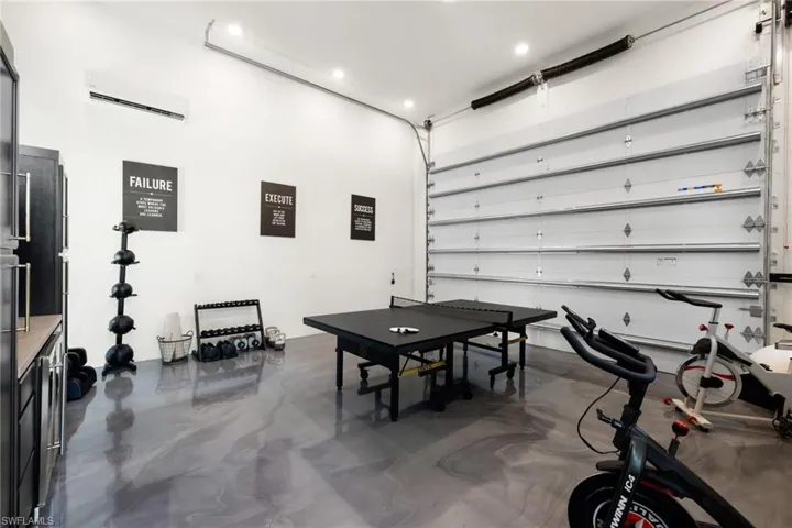 Game room with concrete floors and a garage