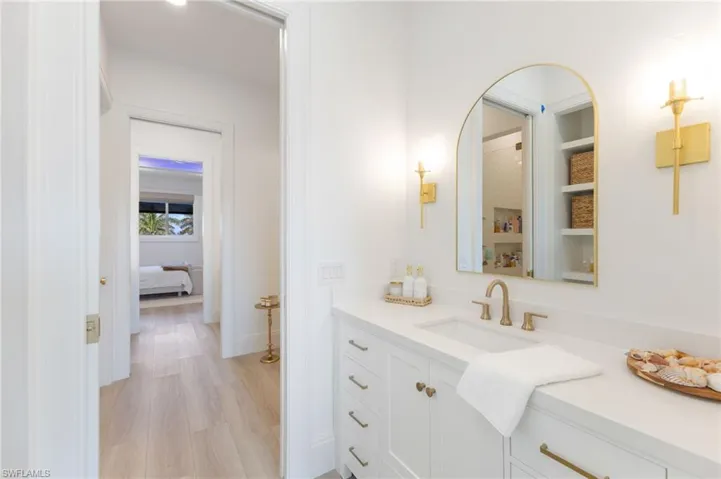 Ensuite bathroom with vanity and light wood finished floors