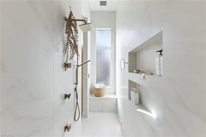 Bathroom featuring a marble finish shower