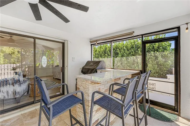 outdoor kitchen with gas grill, beverage fridge & 4 barstools