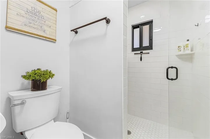 Primary modern bathroom with a walk-in tile shower featuring rain shower, 2nd shower head and water closet