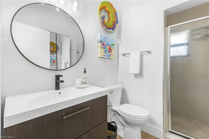 Full Bathroom with a walk-in tile shower, vanity and large mirrored armoire