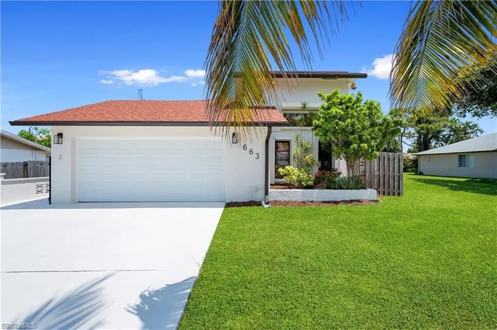 View of front facade featuring concrete driveway, stucco siding, landscaping and a 2 car garage