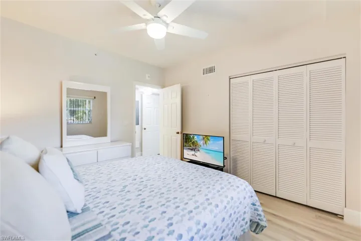 Bedroom featuring light wood-type flooring, a closet, and ceiling fan