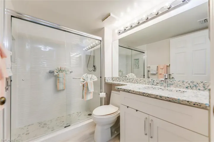 Bathroom with a stall shower and vanity