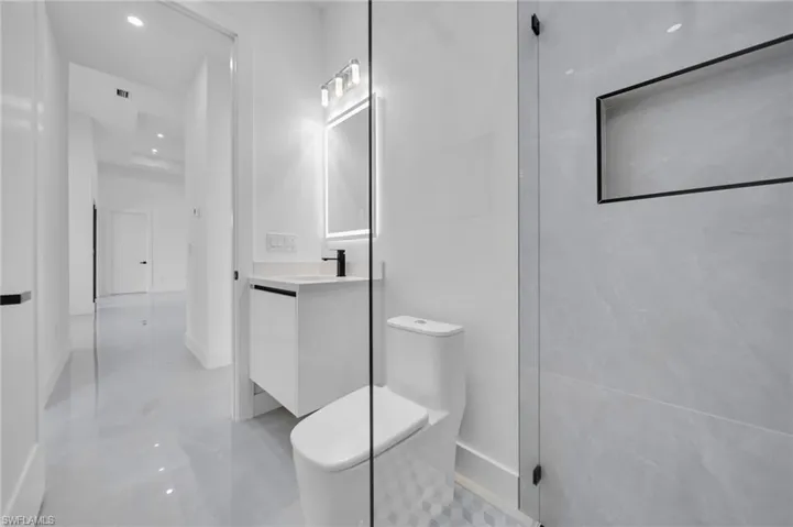 Full bathroom featuring vanity and recessed lighting