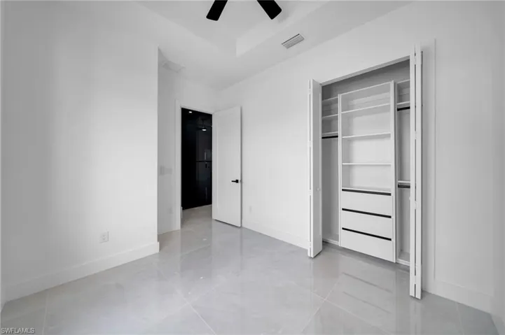 Unfurnished bedroom with a closet and a ceiling fan