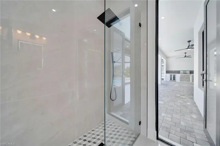 Full bath with a walk in shower, a ceiling fan, and french doors