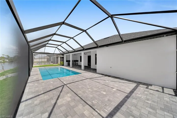 Outdoor pool featuring a patio, a ceiling fan, and a lanai