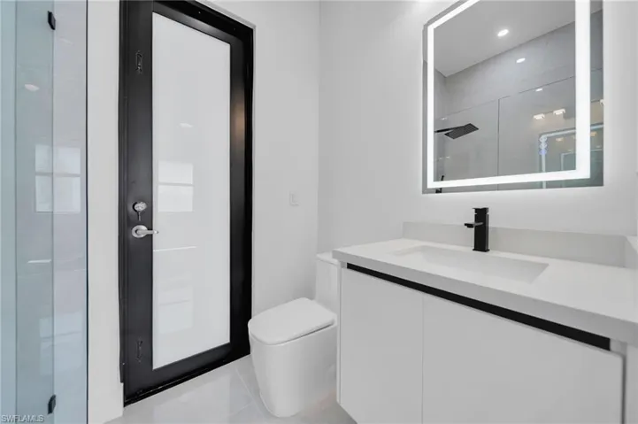 Full bath featuring vanity, tile patterned floors, and a shower