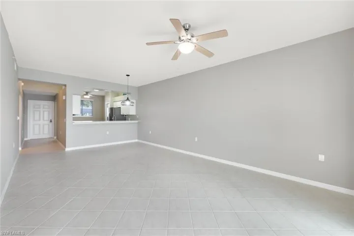 Unfurnished living room with ceiling fan