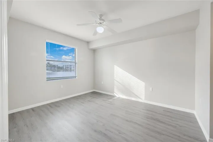 Spare room with ceiling fan and wood-type flooring